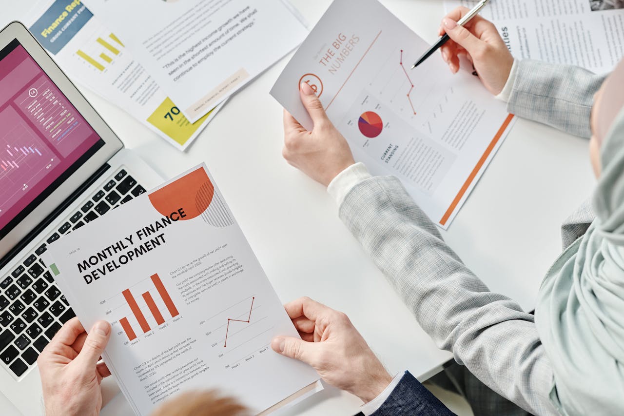 Top view of business colleagues analyzing financial reports during a meeting at the office.